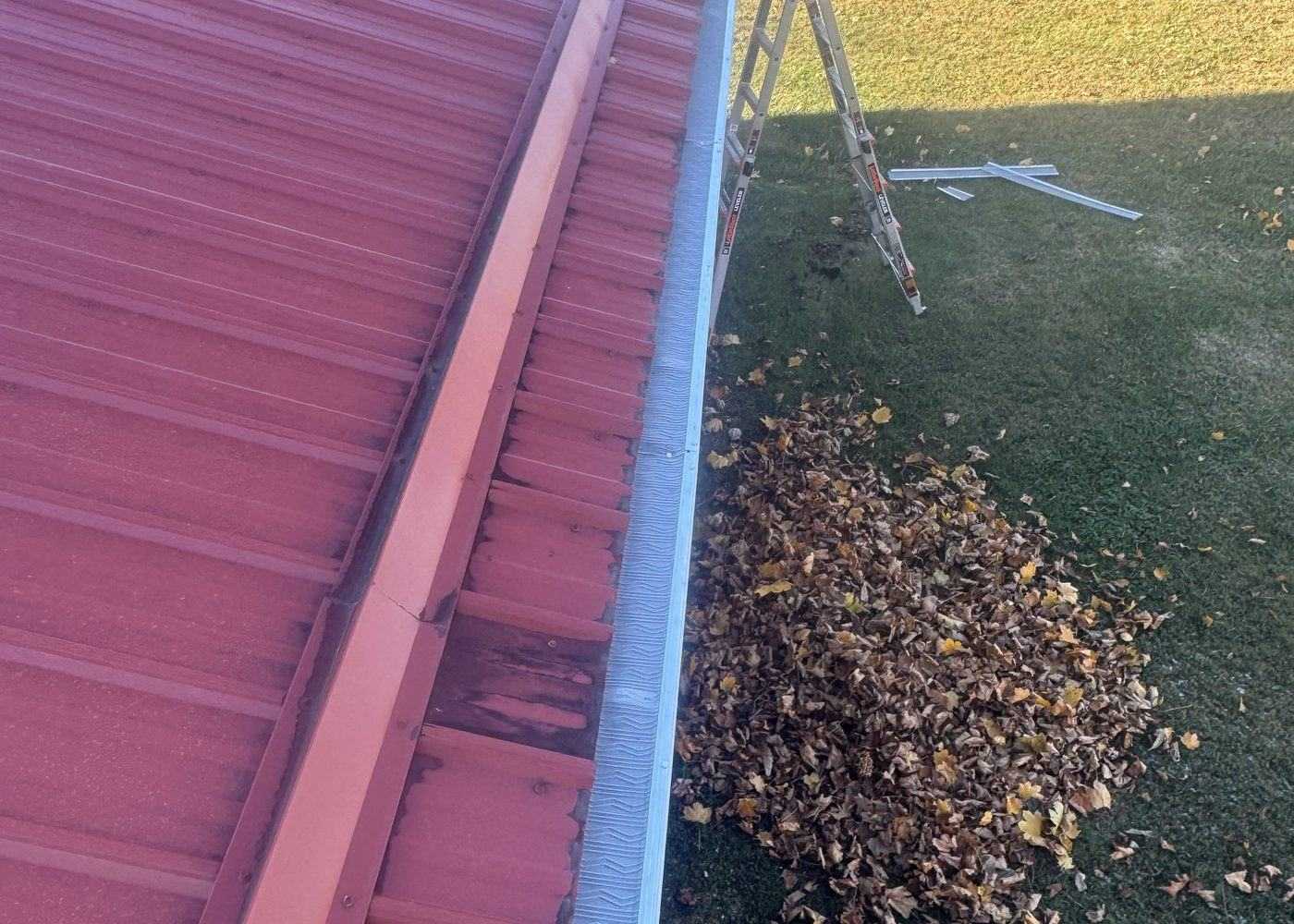 Storm debris in a metal gutter — before repair